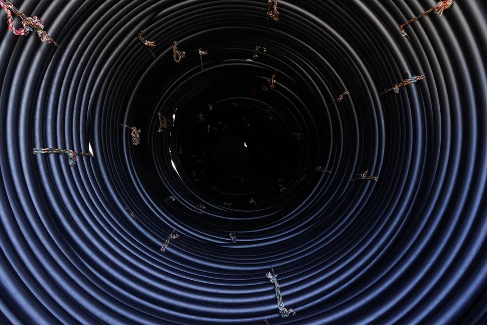 Coiled polyethylene pipes ready for storage at Bukan Pipe